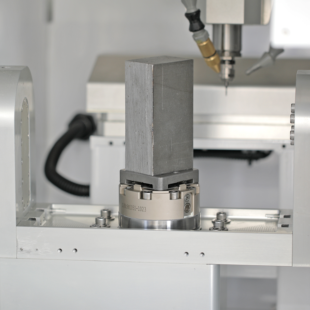 A workpiece blank mounted on the QRS mini pallet, seated in the chuck on the B platter beneath the spindle